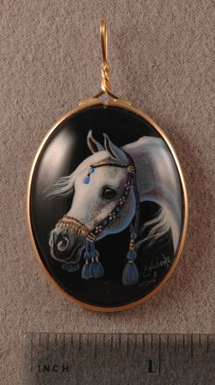 Gray Arabian Horse painted on a 30x40mm Black Onyx cabochon with a native costume halter in light blue and gold in a 14K gold filled setting for use as a pendent.